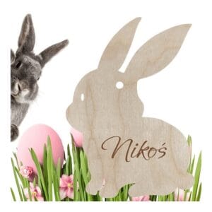 Drewniana zawieszka wielkanocna zajączek ze sklejki z personalizowanym grawerem imienia Nikoś w trawie.